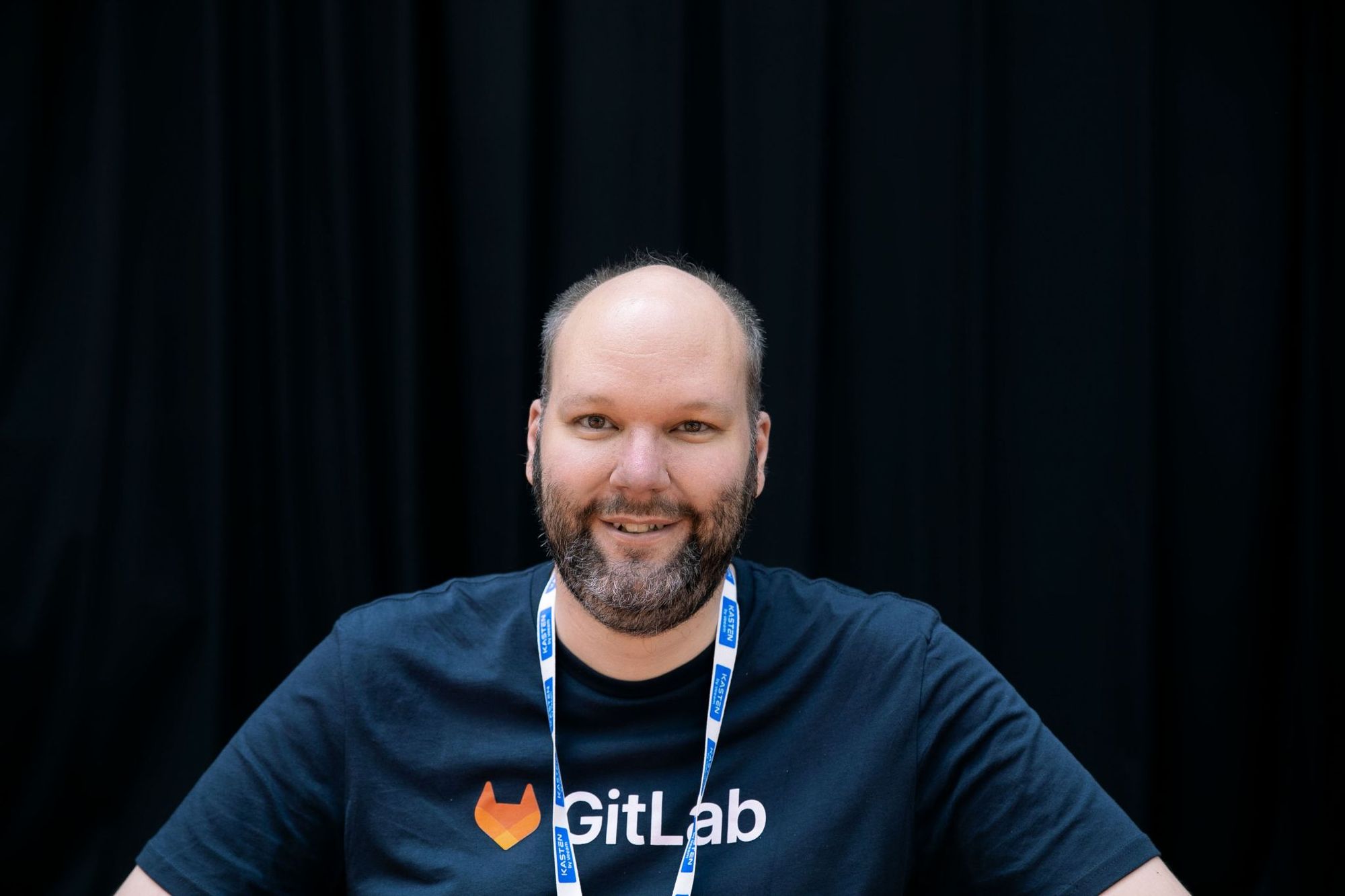 Michael Friedrich, wearing a GitLab shirt, before his KubeCon EU 2022 talk